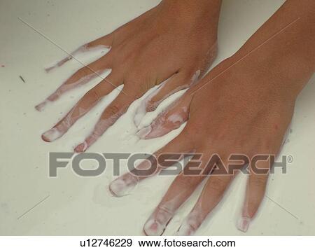 Stock Photo -  Randolph, VT, Vermont, New World Festival, childs hands in liquid cement, close-up. Fotosearch
