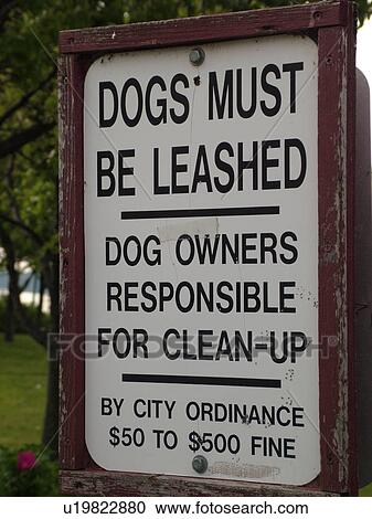 Stock Image -  sign, Dogs Must Be Leashed, Dog Owners Responsible for Clean-up, . Fotosearch