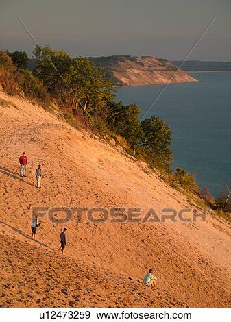 Stock Photo -  Sleeping Bear Sand Dunes National Lakeshore, MI, Michigan, Lake Michigan, from overlook, Pierce Stocking Scenic Drive, dunes, people climbing the dune. Fotosearch