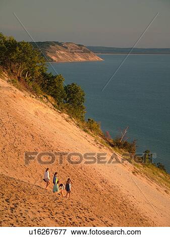 Stock Photo -  Sleeping Bear Sand Dunes National Lakeshore, MI, Michigan, Lake Michigan, from overlook, Pierce Stocking Scenic Drive, dunes, people climbing the dune. Fotosearch