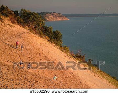 Stock Photograph -  Sleeping Bear Sand Dunes National Lakeshore, MI, Michigan, Lake Michigan, from overlook, Pierce Stocking Scenic Drive, dunes, people climbing the dune. Fotosearch