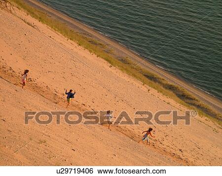 Sleeping Bear Sand Dunes National Lakeshore, MI, Michigan, Lake Michigan, from overlook, Pierce Stocking Scenic Drive, dunes, people climbing the dune View Large Photo Image Stock Photograph - Sleeping Bear Sand Dunes National Lakeshore, MI, Michigan, Lake Michigan, from overlook, Pierce Stocking Scenic Drive, dunes, people climbing the dune. Fotosearch