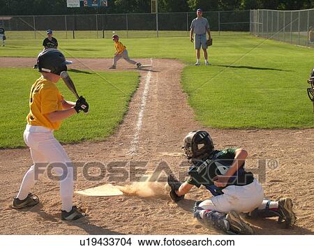 St. Joseph, MN, Minnesota, Boys Little League Baseball Game, catching ball at home plate, batter strikes, runner on first base View Large Photo Image Picture - St. Joseph, MN, Minnesota, Boys Little League Baseball Game, catching ball at home plate, batter strikes, runner on first base. Fotosearch