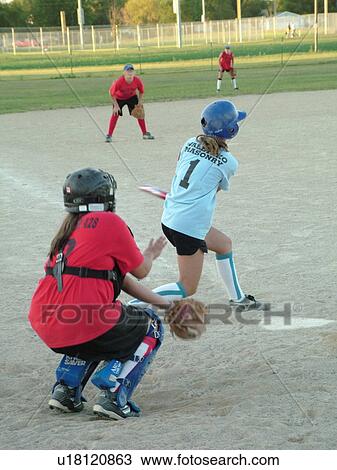 St. Joseph, MN, Minnesota, Girls Babe Ruth Softball Game, Little League, Baseball, batter swings at ball, catcher ready View Large Photo Image Stock Image - St. Joseph, MN, Minnesota, Girls Babe Ruth Softball Game, Little League, Baseball, batter swings at ball, catcher ready. Fotosearch