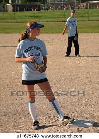 Stock Photo -  St. Joseph, MN, Minnesota, Girls Babe Ruth Softball Game, Little League, Baseball, first baseman, position. Fotosearch