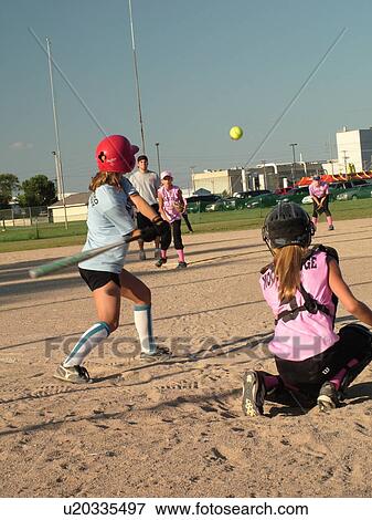 St. Joseph, MN, Minnesota, Girls Babe Ruth Softball Game, Little League, Baseball, batter swings at ball, pitcher throws the ball View Large Photo Image Stock Photo - St. Joseph, MN, Minnesota, Girls Babe Ruth Softball Game, Little League, Baseball, batter swings at ball, pitcher throws the ball. Fotosearch