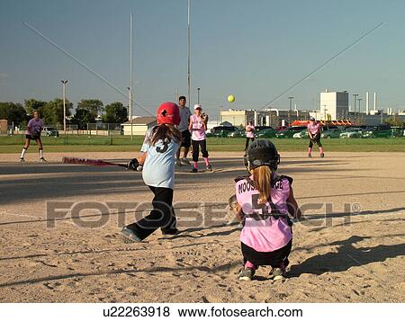 St. Joseph, MN, Minnesota, Girls Babe Ruth Softball Game, Little League, Baseball, batter swings at ball, pitcher throws the ball View Large Photo Image Stock Photo - St. Joseph, MN, Minnesota, Girls Babe Ruth Softball Game, Little League, Baseball, batter swings at ball, pitcher throws the ball. Fotosearch