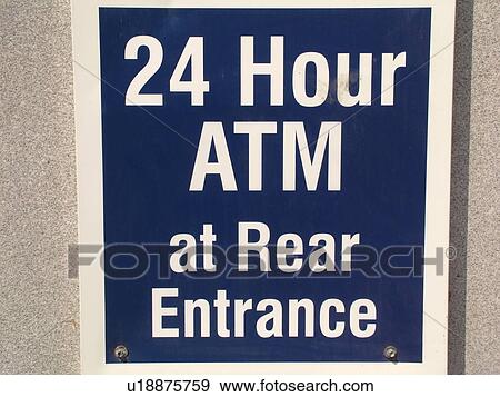 Stock Photo -  street sign, 24 Hour ATM at Rear Entrance. Fotosearch