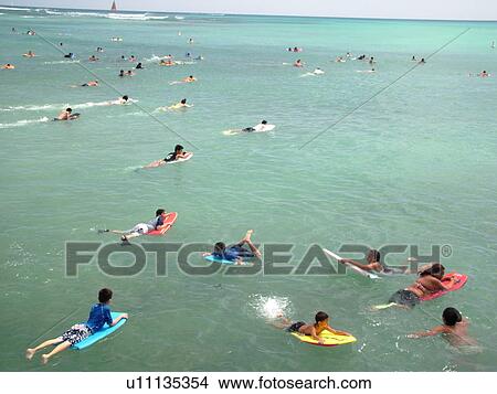 Picture -  Waikiki, Honolulu, Oahu, HI, Hawaii, Queen's Surf Beach, boogie boarding. Fotosearch