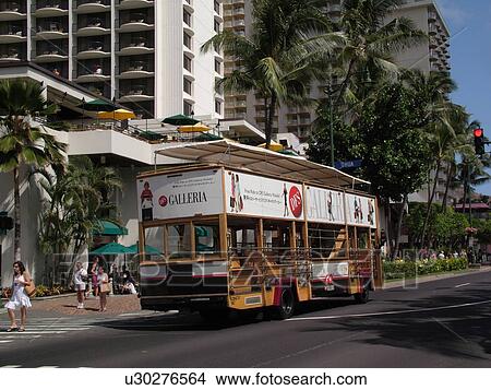 Picture -  Waikiki, Honolulu, Oahu, HI, Hawaii, Kalakaua Avenue, sightseeing tour bus. Fotosearch
