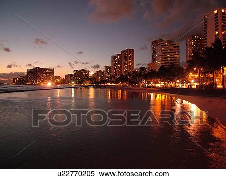 Stock Photography -  Waikiki, Honolulu, Oahu, HI, Hawaii, Kuhio Beach Park, beachfront, skyline, evening. Fotosearch