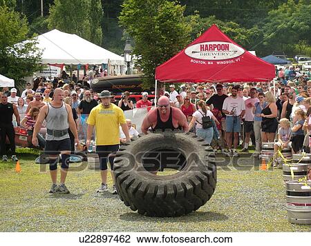 Windsor, VT, Vermont, Harpoon Championships of New England Barbecue, Strong Man Competition, man lift and pushing huge heavy rubber tire View Large Photo Image Stock Image - Windsor, VT, Vermont, Harpoon Championships of New England Barbecue, Strong Man Competition, man lift and pushing huge heavy rubber tire. Fotosearch