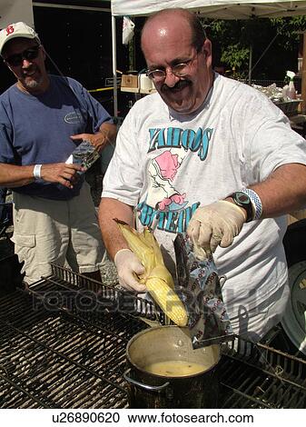 Stock Image -  Windsor, VT, Vermont, Harpoon Championships of New England Barbecue, Harpoon Brewery, Yahoos BBQ team selling roasted corn-on-the-cob dipped in melted butter. Fotosearch
