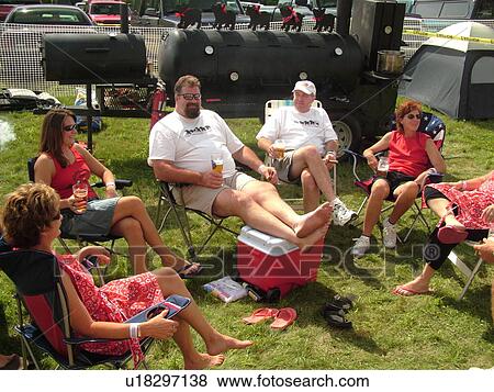 Stock Photo -  Windsor, VT, Vermont, Harpoon Championships of New England Barbecue, Harpoon Brewery, BBQ team sitting around relaxing. Fotosearch