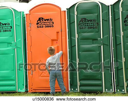 Stock Photograph -  Windsor, VT, Vermont, Harpoon Championships of New England Barbecue, Harpoon Brewery, Ron's Johns, port-o-lets, bathrooms, young boy waiting to use the port-o-let. Fotosearch