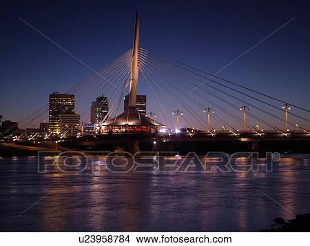 Picture -  Winnipeg, Canada, MB, Manitoba, Provencher Bridge & Esplanade Riel Pedestrian Bridge, evening. Fotosearch