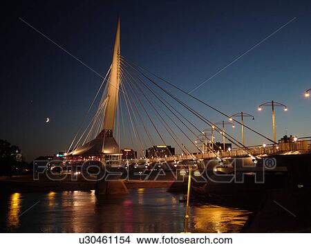 Picture -  Winnipeg, Canada, MB, Manitoba, Provencher Bridge & Esplanade Riel Pedestrian Bridge, evening. Fotosearch
