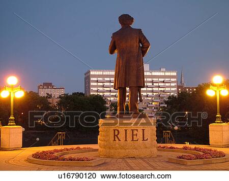 Stock Image -  Winnipeg, Canada, MB, Manitoba, Manitoba Legislative Building Grounds, The Louis Riel Statue facing the Assiniboine River, evening. Fotosearch