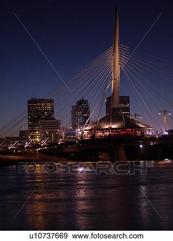 Stock Photo -  Winnipeg, Canada, MB, Manitoba, Provencher Bridge & Esplanade Riel Pedestrian Bridge, evening. Fotosearch