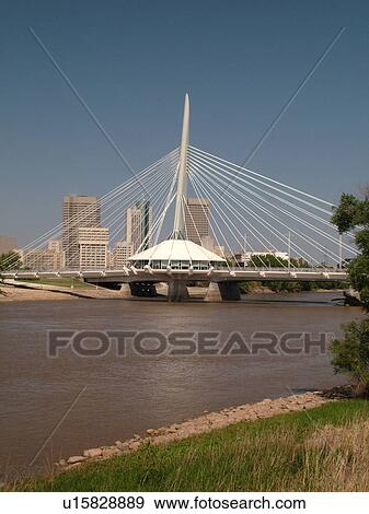 Stock Photo -  Winnipeg, Canada, MB, Manitoba, Provencher Bridge & Esplanade Riel Pedestrian Bridge, Red River, skyline. Fotosearch
