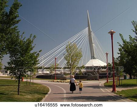 Stock Photography -  Winnipeg, Canada, MB, Manitoba, Provencher Bridge & Esplanade Riel Pedestrian Bridge, Red River, City Park. Fotosearch