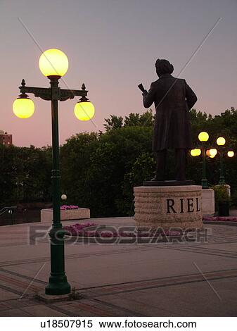 Stock Photography -  Winnipeg, Canada, MB, Manitoba, Manitoba Legislative Building Grounds, The Louis Riel Statue facing the Assiniboine River, evening. Fotosearch