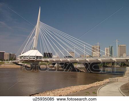 Stock Photography -  Winnipeg, Canada, MB, Manitoba, Provencher Bridge & Esplanade Riel Pedestrian Bridge, Red River, skyline. Fotosearch
