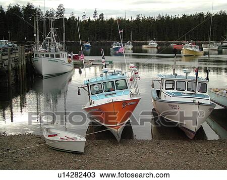 Stock Image -  Winter Harbor, ME, Maine, Mount Desert Island, Atlantic Ocean, Frenchman Bay, lobster boats, low tide. Fotosearch