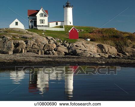 Stock Image -  York Beach, ME, Maine, Cape Neddick Nubble Light, Lighthouse, reflection, calm water. Fotosearch