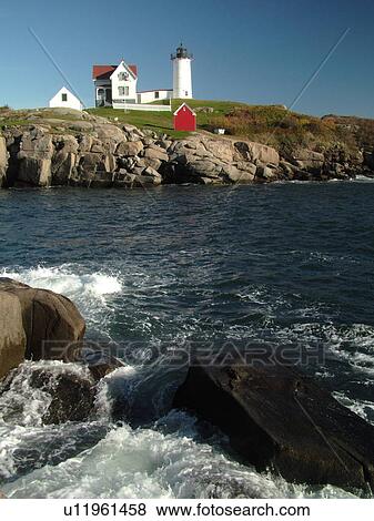 Stock Photo -  York Beach, ME, Maine, Cape Neddick Nubble Light, Lighthouse, waves crashing along the rocky coastline. Fotosearch