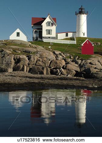 Stock Photograph -  York Beach, ME, Maine, Cape Neddick Nubble Light, Lighthouse, reflection, calm water. Fotosearch