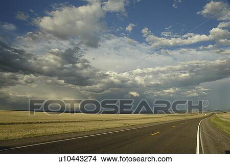 Picture -  Albany County, WY, Wyoming, road, prairie, rain clouds, open range. Fotosearch