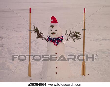 Alexandria, MN, Minnesota, Maple Lake, snowman wearing a red Santa hat holding oars, snow, winter View Large Photo Image Picture - Alexandria, MN, Minnesota, Maple Lake, snowman wearing a red Santa hat holding oars, snow, winter. Fotosearch