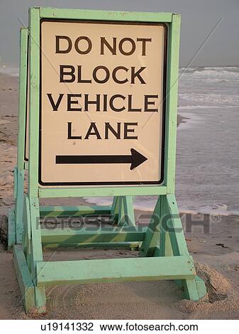 Stock Image -  Daytona Beach, FL, Florida, Daytona Beach Shores, Atlantic Ocean, beach sign, restrictions, regulatory signs, do not block vehicle lane. Fotosearch