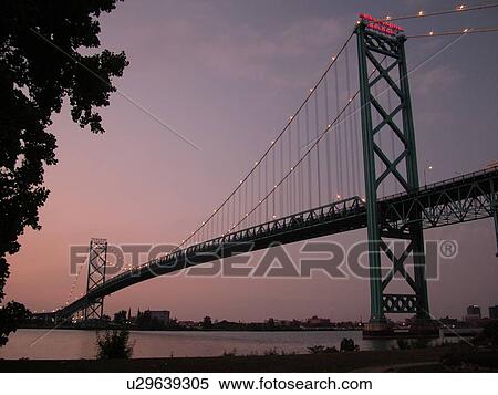 Stock Photography -  Detroit, MI, Michigan, Detroit River, Windsor, Ontario, Canada, Ambassador Bridge, evening. Fotosearch
