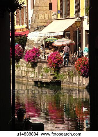 Picture -  France, Annecy, Haute-Savoie, Rhone-Alpes, Europe, Thiou Canal, flower-covered pedestrian streets, restaurants, outdoor cafT, village, old quarter. Fotosearch