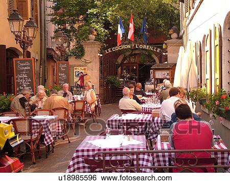 Stock Photograph -  France, Annecy, Haute-Savoie, Rhone-Alpes, Europe, Le Cochon a L'Oreille Restaurant, outdoor cafT, village, old quarter. Fotosearch