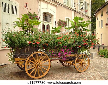 Stock Image -  France, Beaujeu, Rhone-Alpes, Europe, Heart of Beaujolais, flowers decorate the village, wagon. Fotosearch
