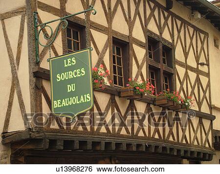 Stock Photograph -  France, Beaujeu, Rhone-Alpes, Europe, Heart of Beaujolais, Les Sources du Beaujolais, tourist office, 17th century half-timbered building. Fotosearch
