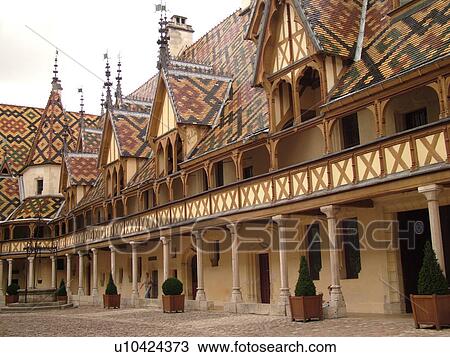 Stock Image -  France, Beaune, Burgundy, Cote de Beaune, Cote d'Or, Europe, Burgundy Wine Region, downtown, Hotel-Dieu, Cour d'Honneur. Fotosearch