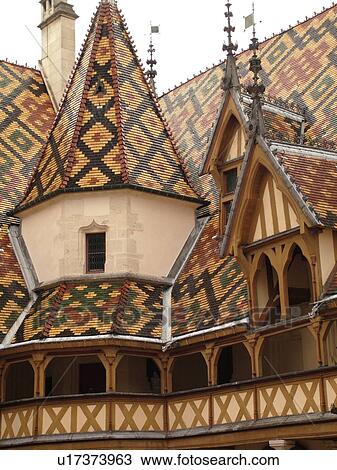 Stock Image -  France, Beaune, Burgundy, Cote de Beaune, Cote d'Or, Europe, Burgundy Wine Region, downtown, Hotel-Dieu, multi-colored Burgundian roof tiles. Fotosearch