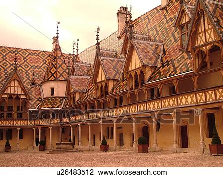 Stock Image -  France, Beaune, Burgundy, Cote de Beaune, Cote d'Or, Europe, Burgundy Wine Region, downtown, Hotel-Dieu, Cour d'Honneur. Fotosearch