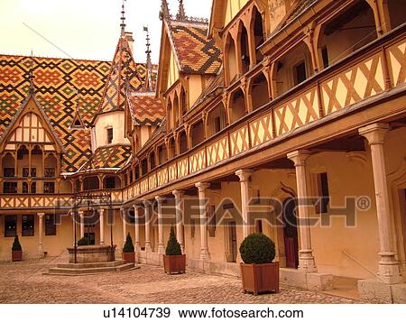 Stock Photo -  France, Beaune, Burgundy, Cote de Beaune, Cote d'Or, Europe, Burgundy Wine Region, downtown, Hotel-Dieu, Cour d'Honneur. Fotosearch
