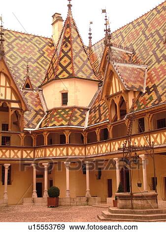 Stock Photo -  France, Beaune, Burgundy, Cote de Beaune, Cote d'Or, Europe, Burgundy Wine Region, downtown, Hotel-Dieu, Cour d'Honneur. Fotosearch