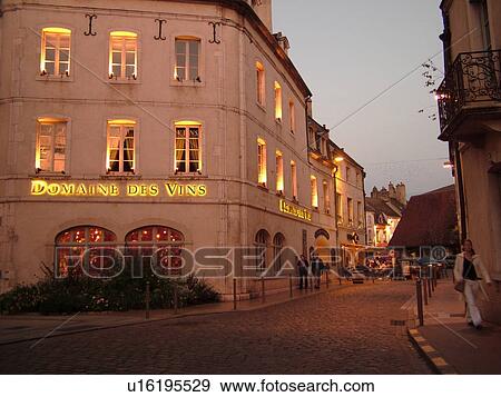 Stock Photo -  France, Beaune, Burgundy, Cote de Beaune, Cote d'Or, Europe, Burgundy Wine Region, downtown, evening, Domaine des Vins. Fotosearch