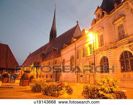 Stock Photo -  France, Beaune, Burgundy, Cote de Beaune, Cote d'Or, Europe, Burgundy Wine Region, downtown, Hotel-Dieu, evening. Fotosearch