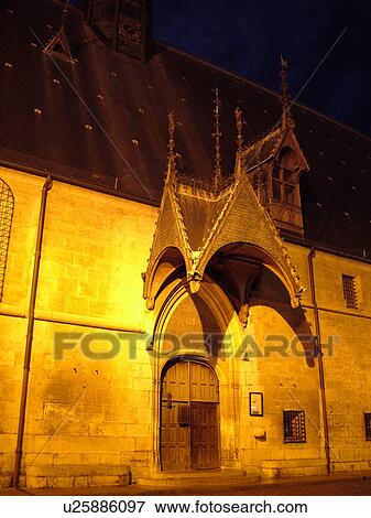 Stock Photo -  France, Beaune, Burgundy, Cote de Beaune, Cote d'Or, Europe, Burgundy Wine Region, downtown, Hotel-Dieu, evening. Fotosearch