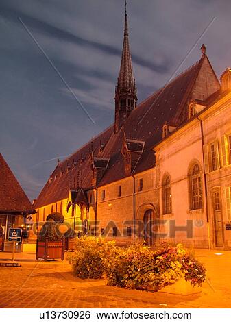 Stock Photograph -  France, Beaune, Burgundy, Cote de Beaune, Cote d'Or, Europe, Burgundy Wine Region, downtown, Hotel-Dieu, evening. Fotosearch