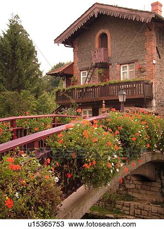 Stock Image -  France, Chatillon, Ain, Rhone-Alpes, Europe, historical house, bridge decorated with flowers. Fotosearch