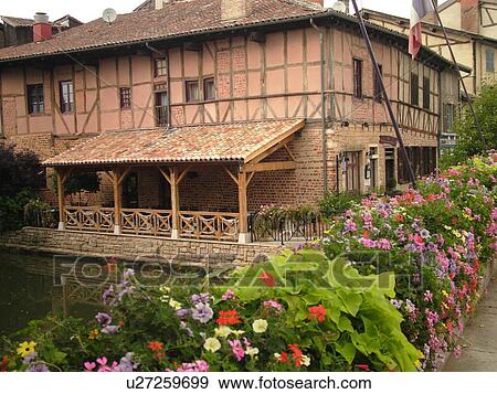 Stock Photo -  France, Chatillon, Ain, Rhone-Alpes, Europe, historical half-timbered house, bridge decorated with flowers. Fotosearch
